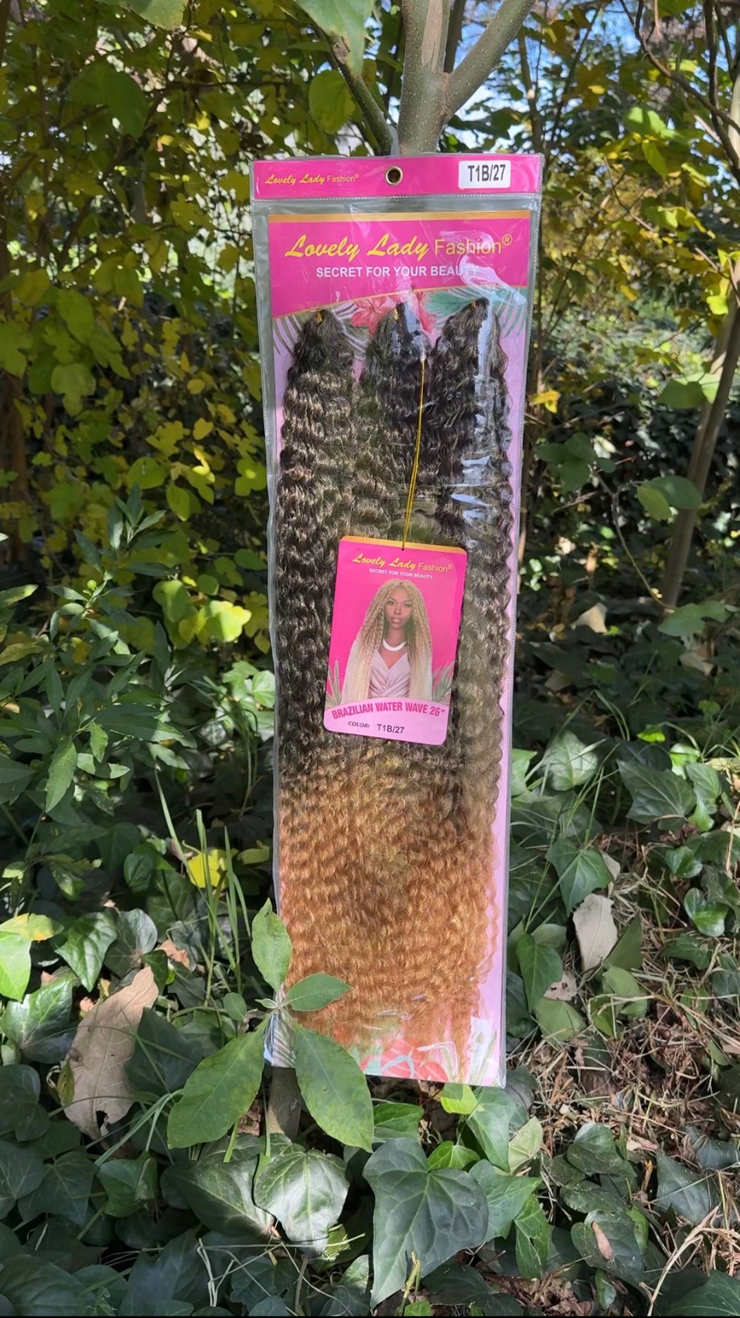 Pack of Lovely Lady Fashion Brazilian Water Wave 26 inch in colour T1B/27 hanging outdoors
